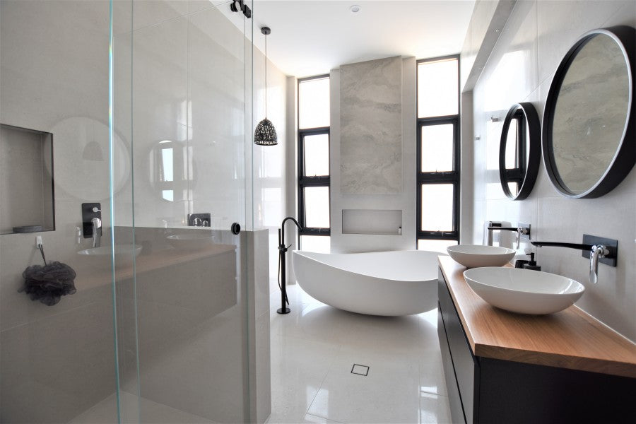 #62 - Bathrooms: Large, bright and vibrant with limestone look tiles and matte black fixtures