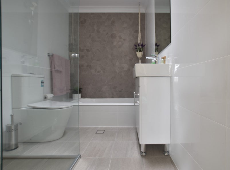 #75 - Bathrooms: Light and bright floors contrast against a cube feature