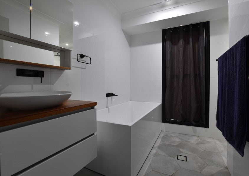 #77 - Bathrooms: Hexagonal floors with all-white walls and a bright inviting atmosphere
