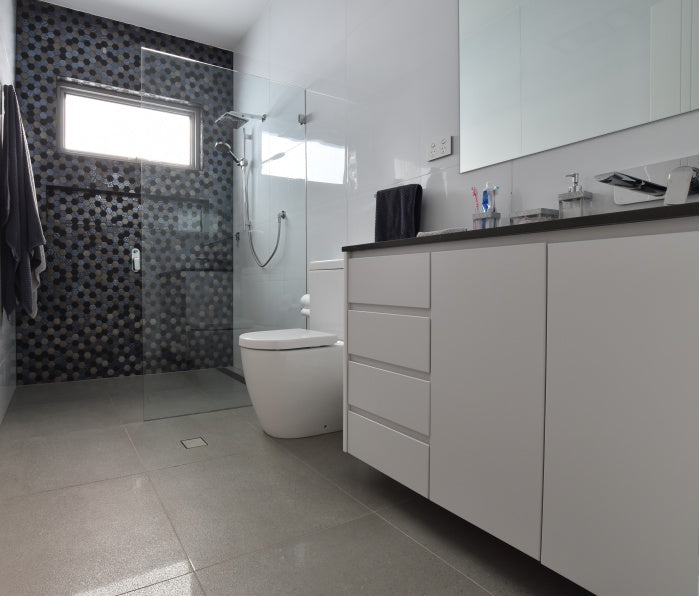 #80 - Bathrooms: Hexagonal mosaic feature wall against a simple all-white