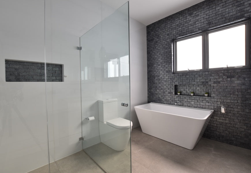 #81 - Bathrooms: A stunning metallic tile laid in brick pattern adorns the feature wall