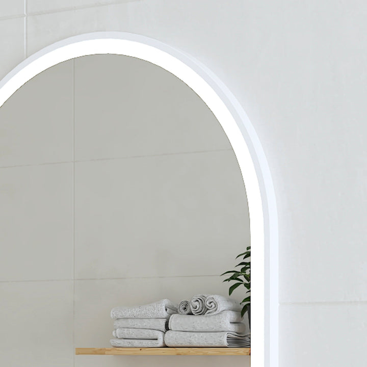 Arch-shaped LED mirror with frosted edge, angled top-right view.