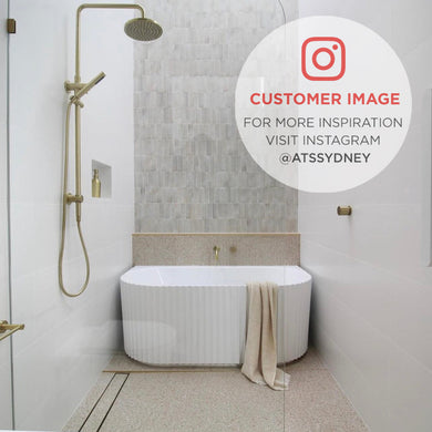 Customer bathroom featuring the Agora Groove 1500mm back to wall bathtub in gloss white