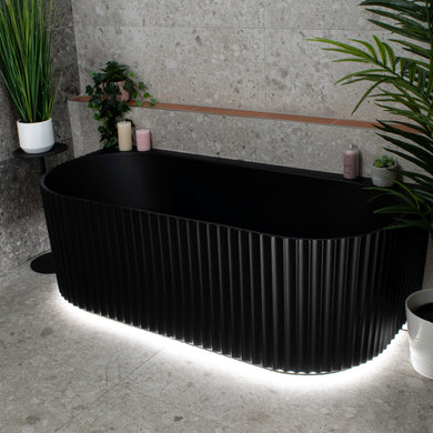 Agora Groove 1500mm back to wall bathtub with LED lights in matte black, angled view