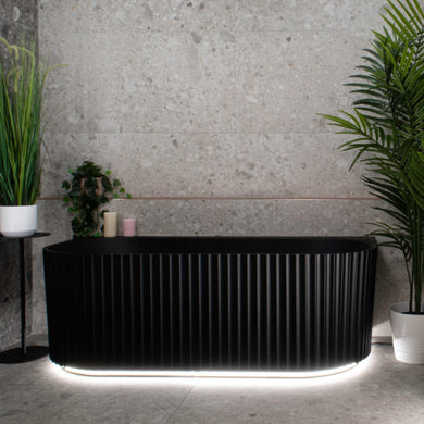 Agora Groove 1500mm back to wall bathtub with LED lights in matte black, front view